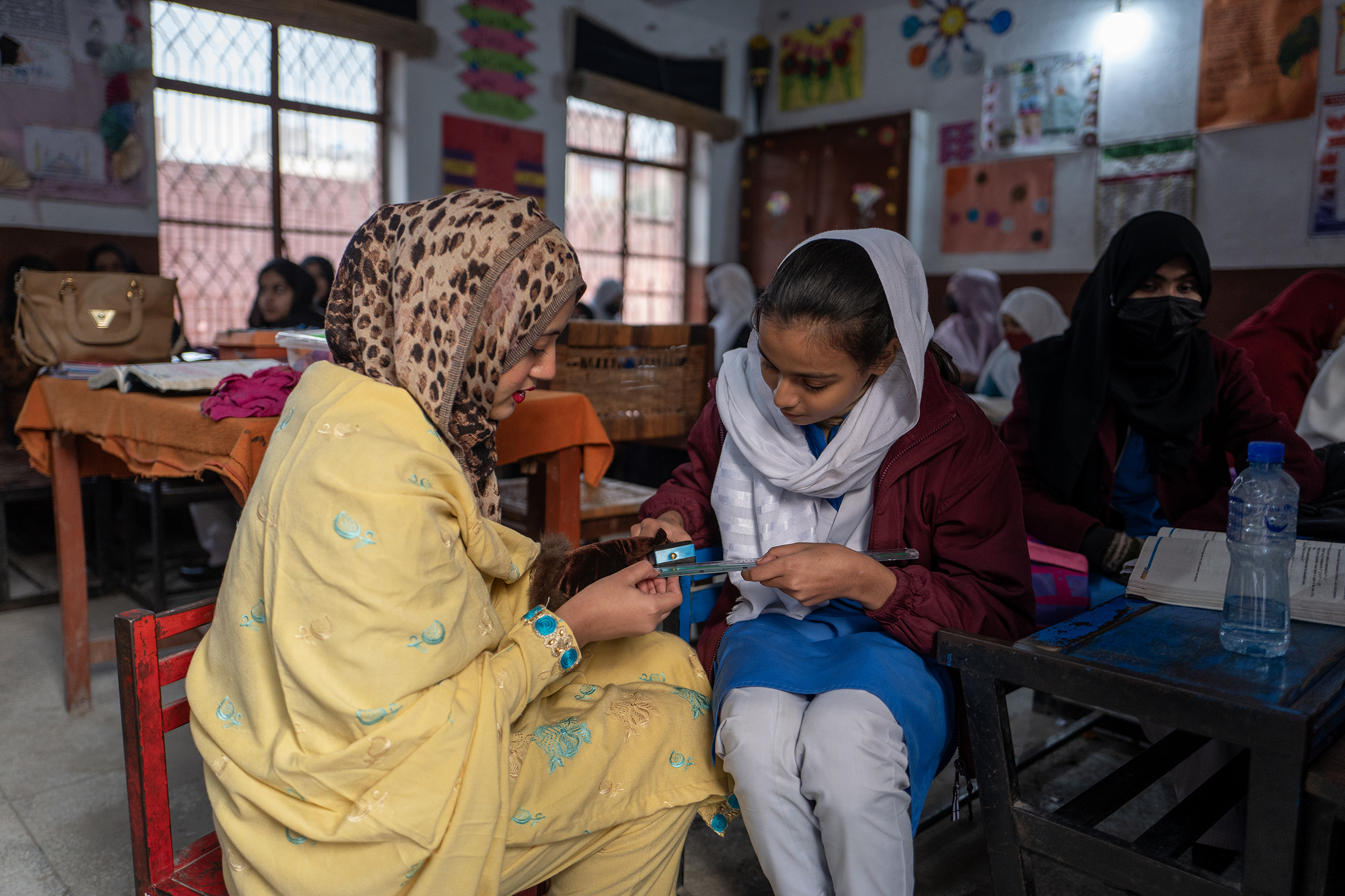 Math teacher Sehar Ali helps Dania measure with a ruler. Grade 8. Afternoon school program at the Government Girls Primary School Nishtar Colony, Lahore, Pakistan. Credit: GPE/Sebastian Rich